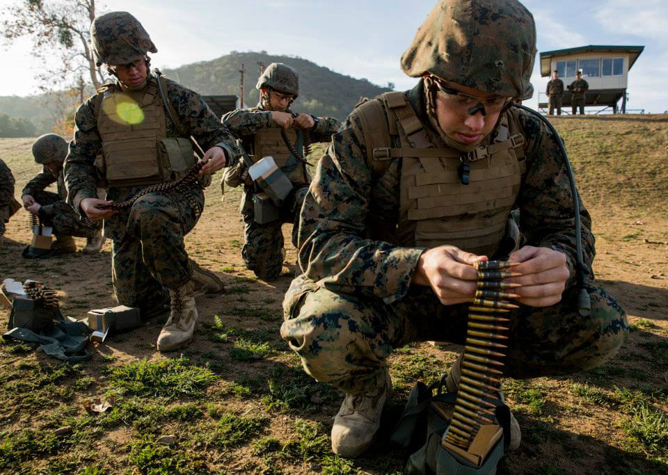 - Marines training to be machine gunners break up their ammunition into dif...